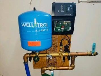 Three pressure gauges are sitting on top of a metal pipe. Three pressure gauges are sitting on top of a metal pipe.
