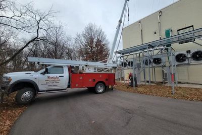 A red and white truck is parked in front of a building. A red and white truck is parked in front of a building.