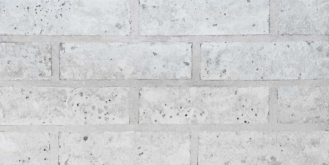 White brick wall with gray mortar.