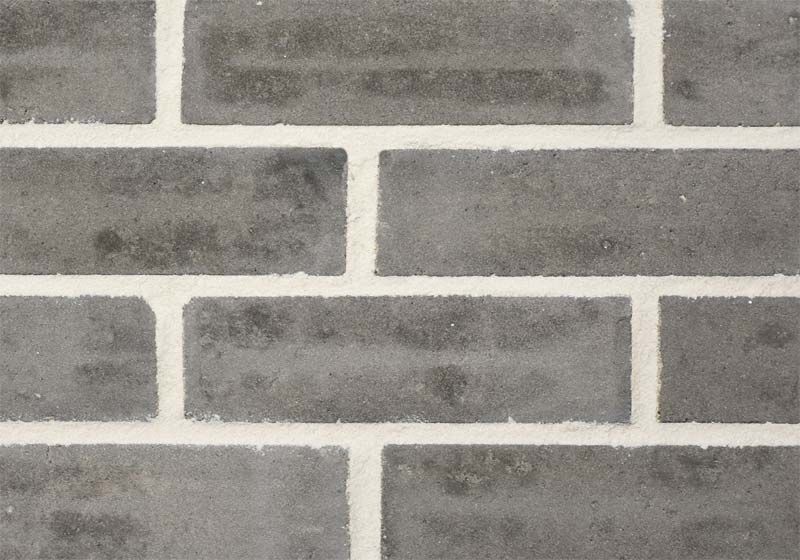 Gray brick wall with white mortar.