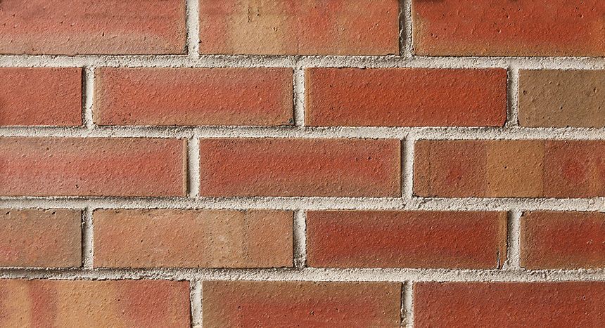 Red brick wall with white mortar.