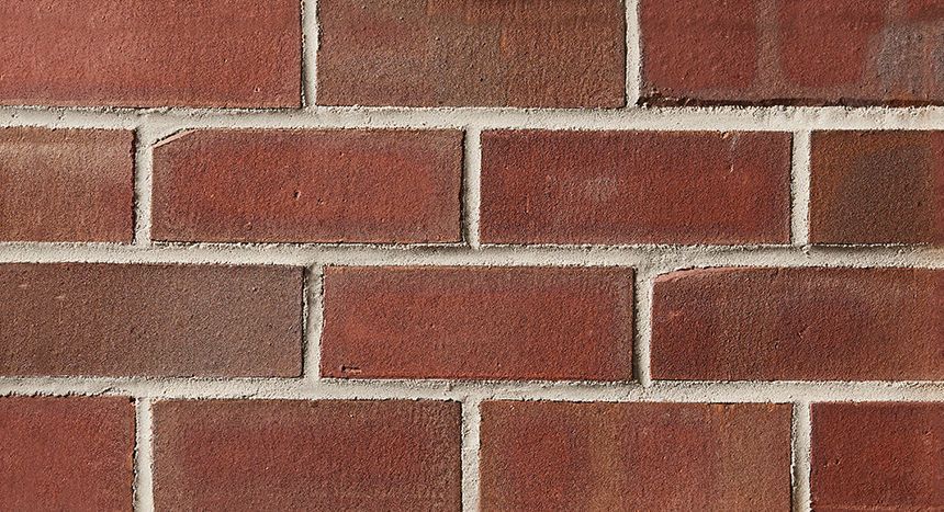 Red brick wall with white mortar.