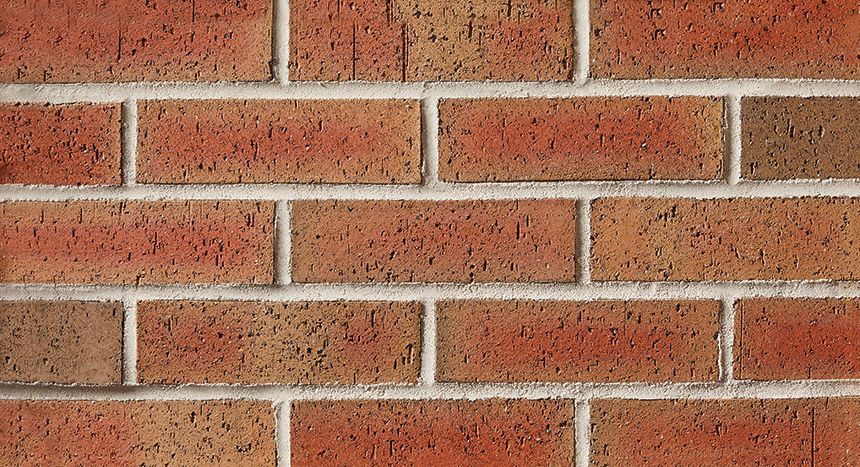 Red brick wall with white mortar.