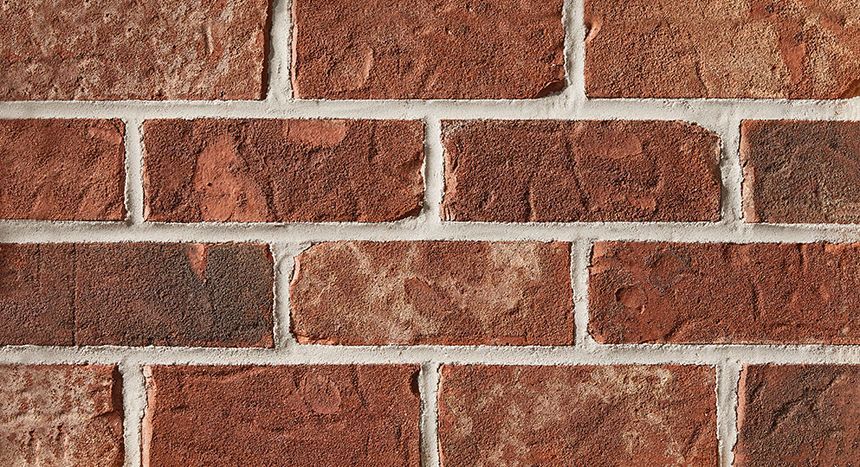 Red brick wall with white mortar.