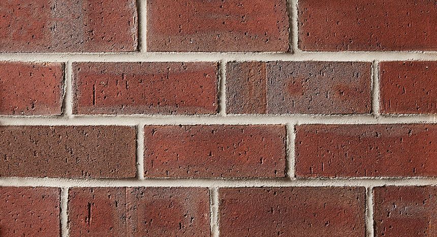 Red brick wall with white mortar.