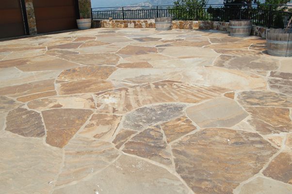 Flagstone patio with tan, brown, and gray irregular shaped stones.