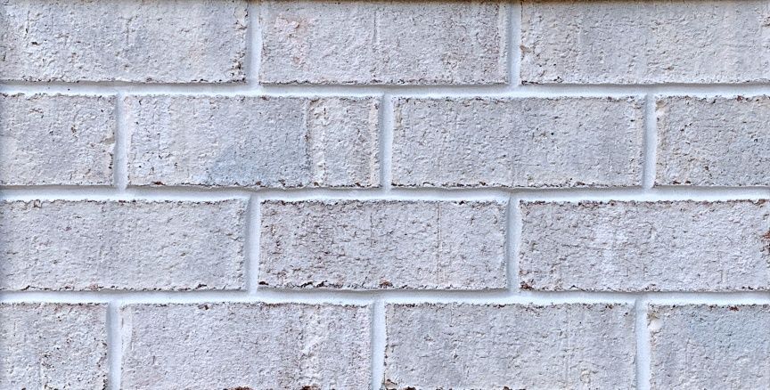 Gray brick wall with white mortar.