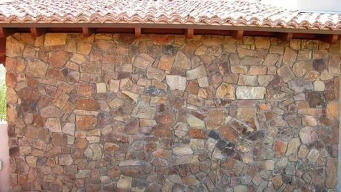 Stone wall with a clay tile roof.