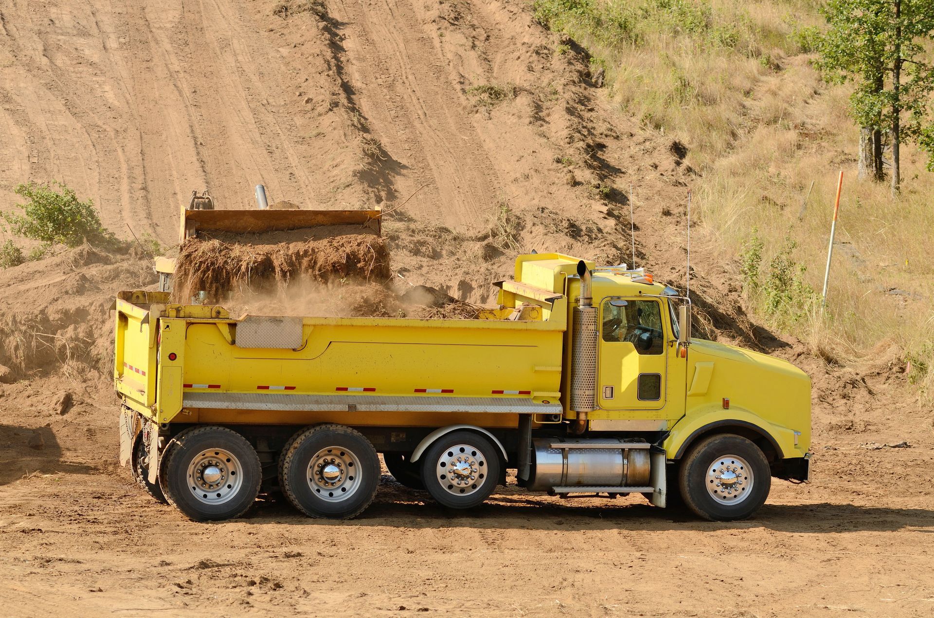 Heavy equipment is preparing land for site work and foundation installation