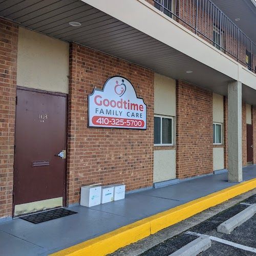 Goodtime Family Cafe storefront; sign on brick building. Three white bags are in front of the door.