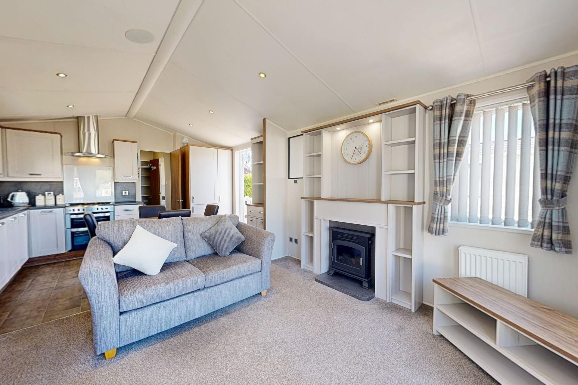 a caravan front room with sofa and fireplace
