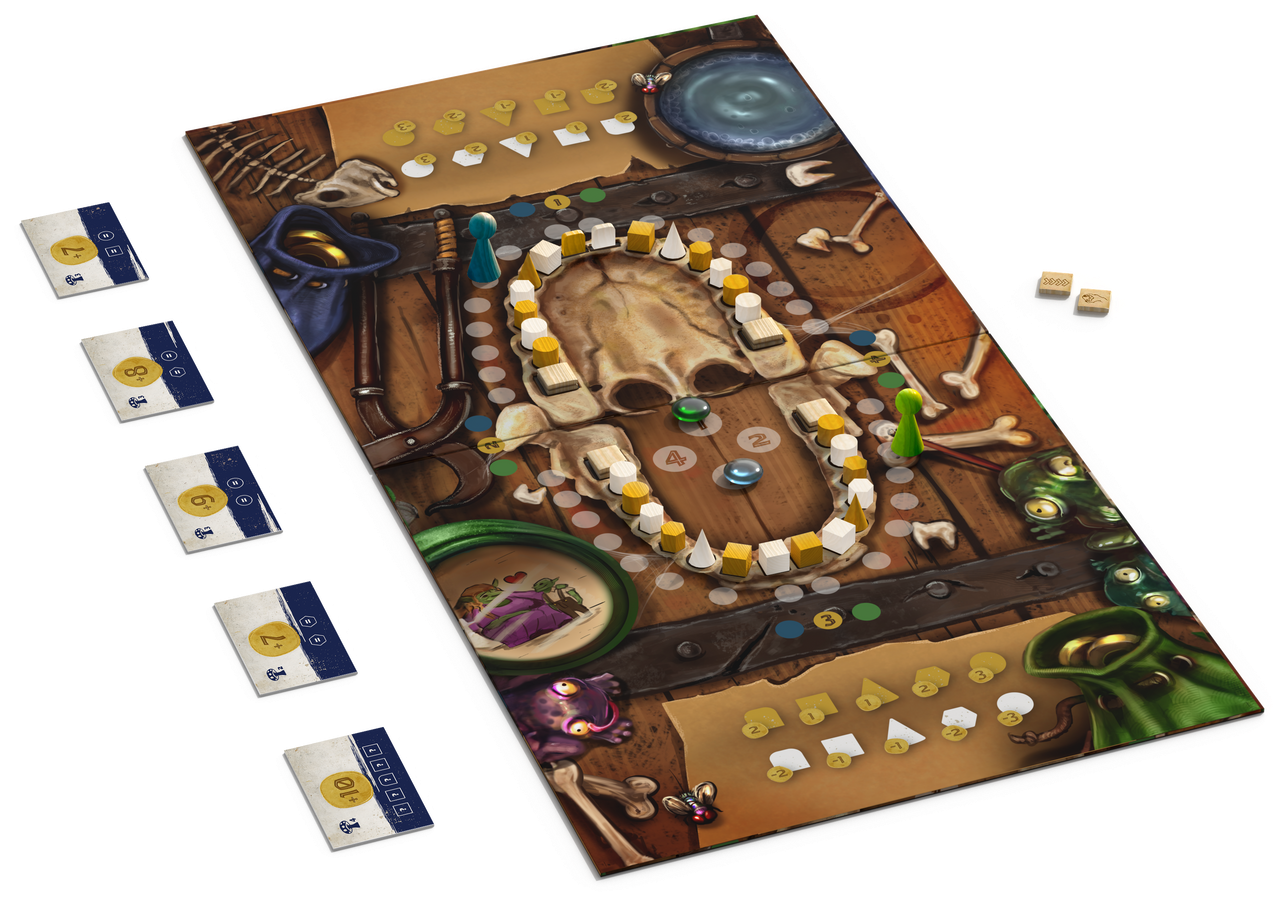 A board game with a wide open mouth full of teeth on it, is sitting on a table.