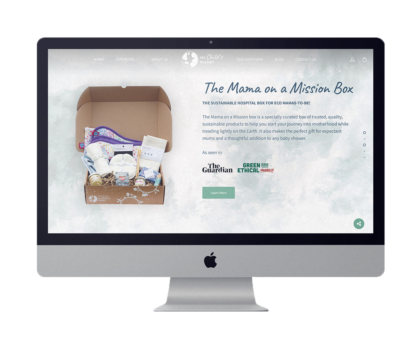A computer monitor is displaying a website for the mama on a mission box.