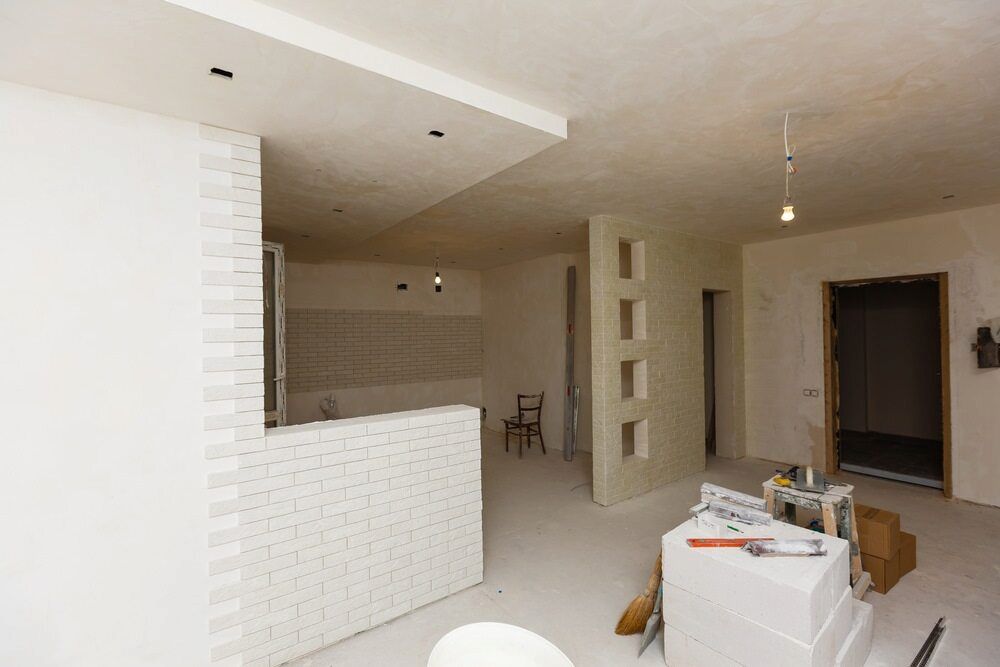 A Room That Is Being Remodeled With White Walls And A Table With Tools — Paxi Homes Brad Clarke in Port Macquarie, NSW
