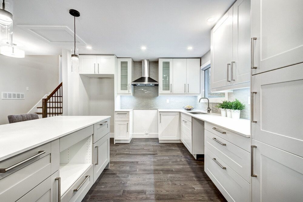 A Kitchen With White Cabinets And Stainless Steel Appliances — Paxi Homes Brad Clarke in Port Macquarie, NSW