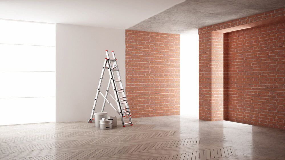 An Empty Room With A Ladder And Paint Buckets In It — Paxi Homes Brad Clarke in Port Macquarie, NSW