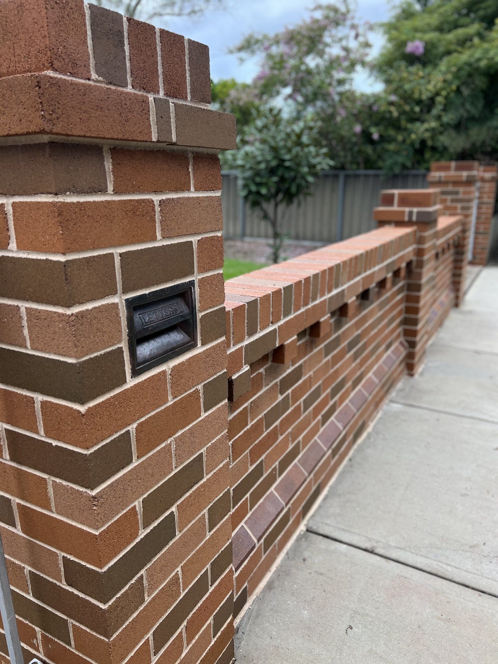 A brick wall with a light on the side of it