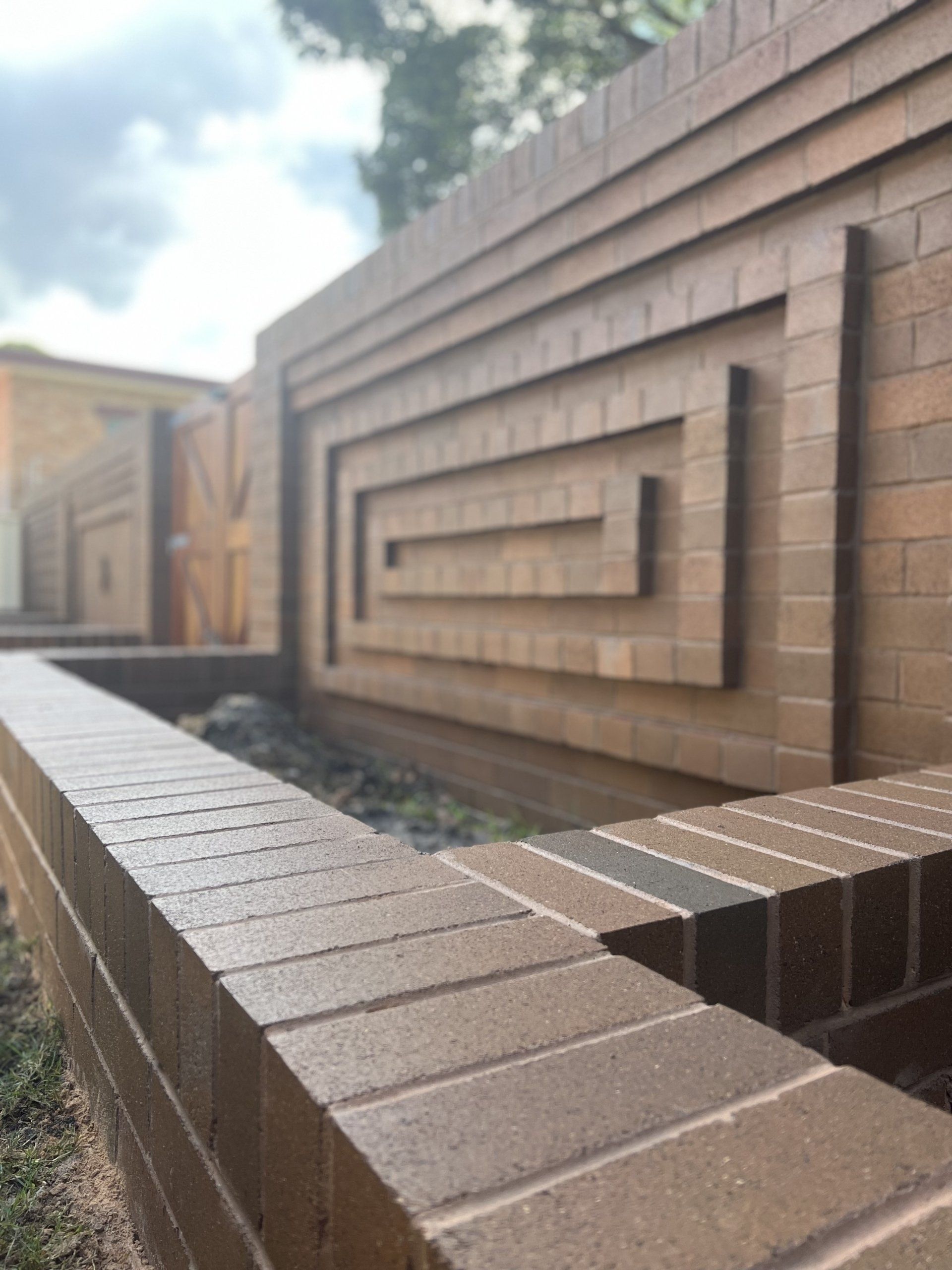 A brick wall with a geometric design on it