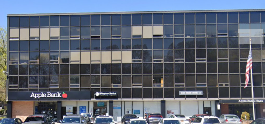 A large building with a sign that says apple bank
