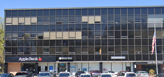 A large building with a sign that says apple bank