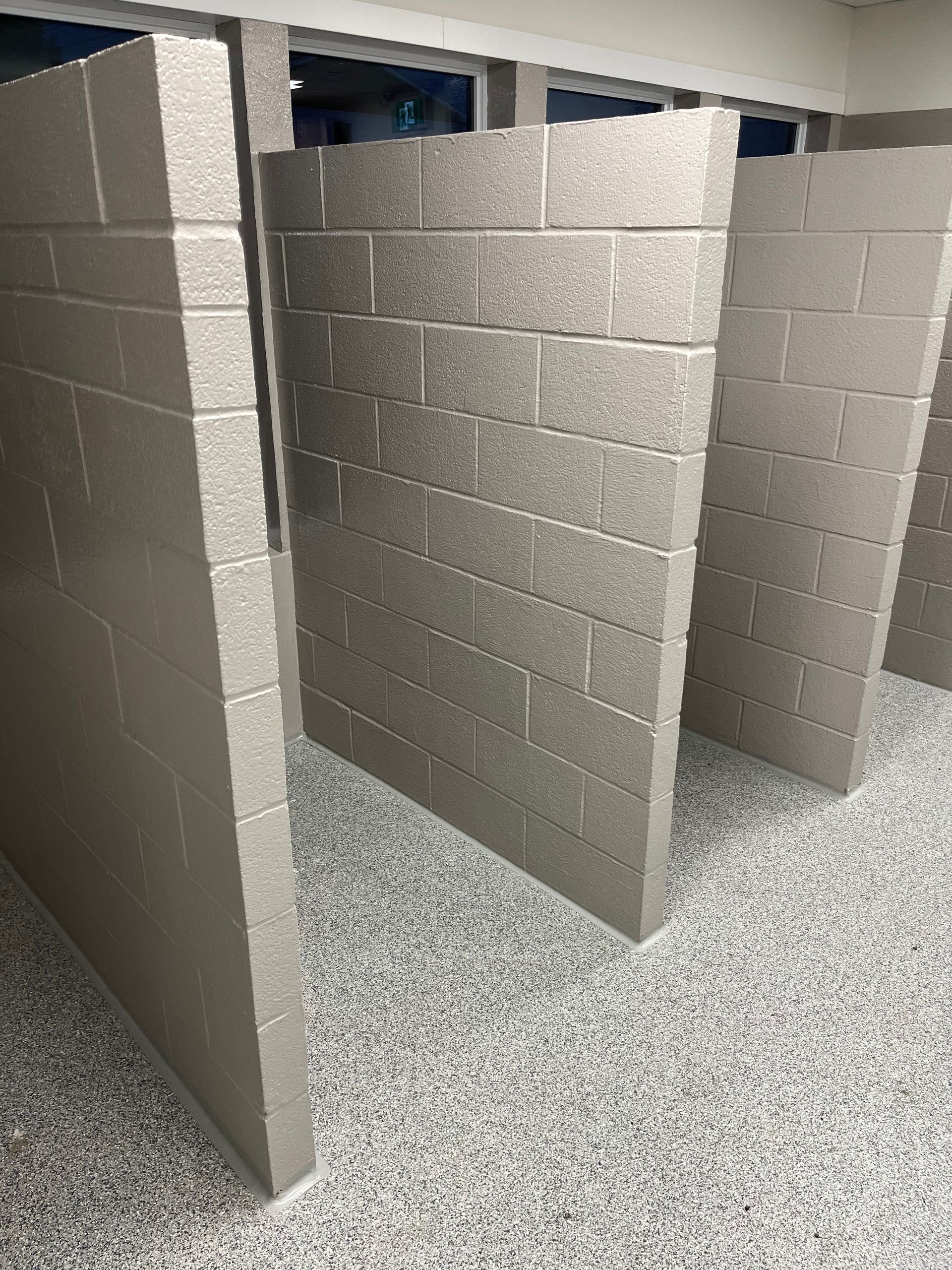A row of brick walls in a bathroom.