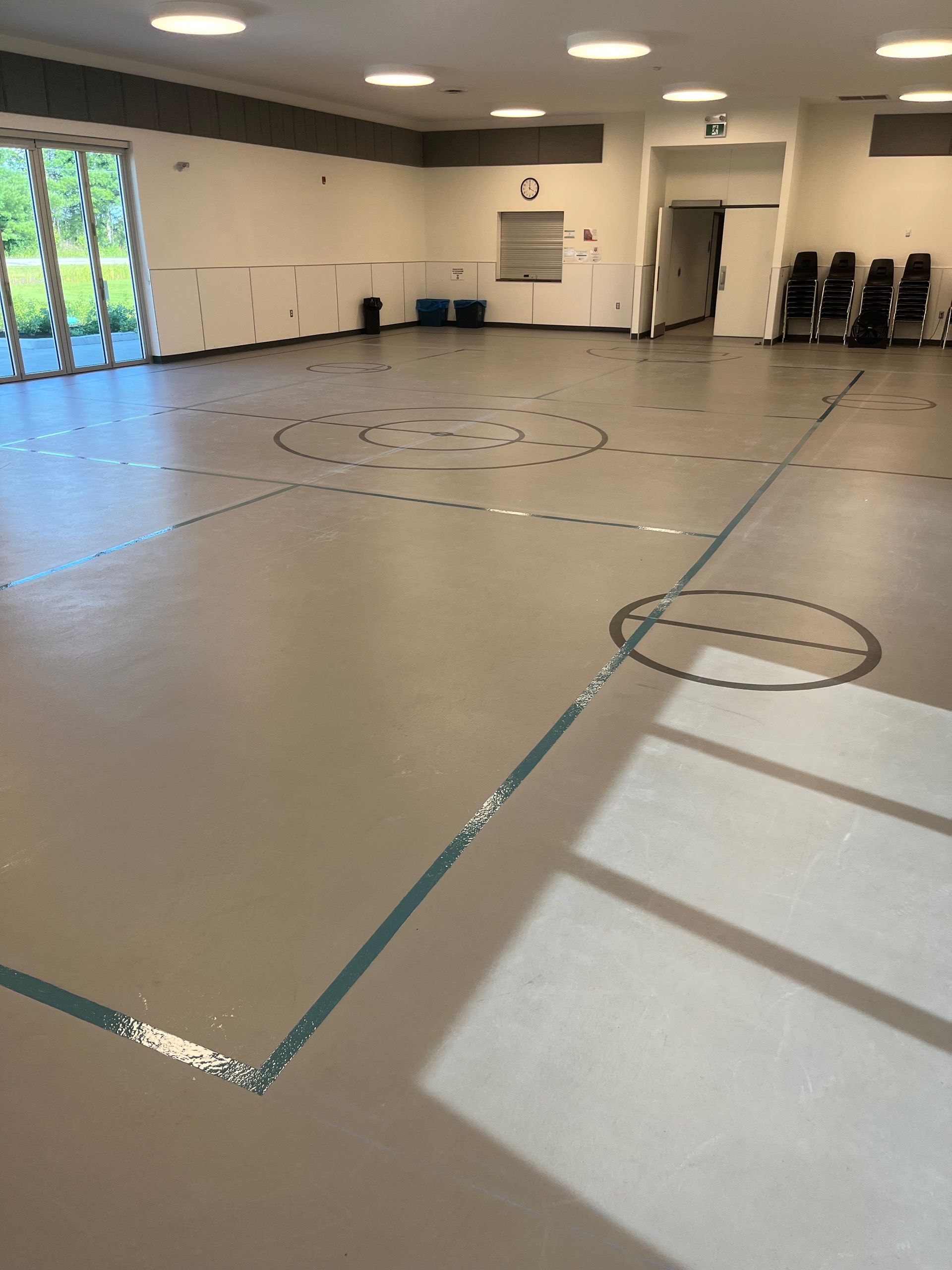 A large empty room with a circle on the floor.