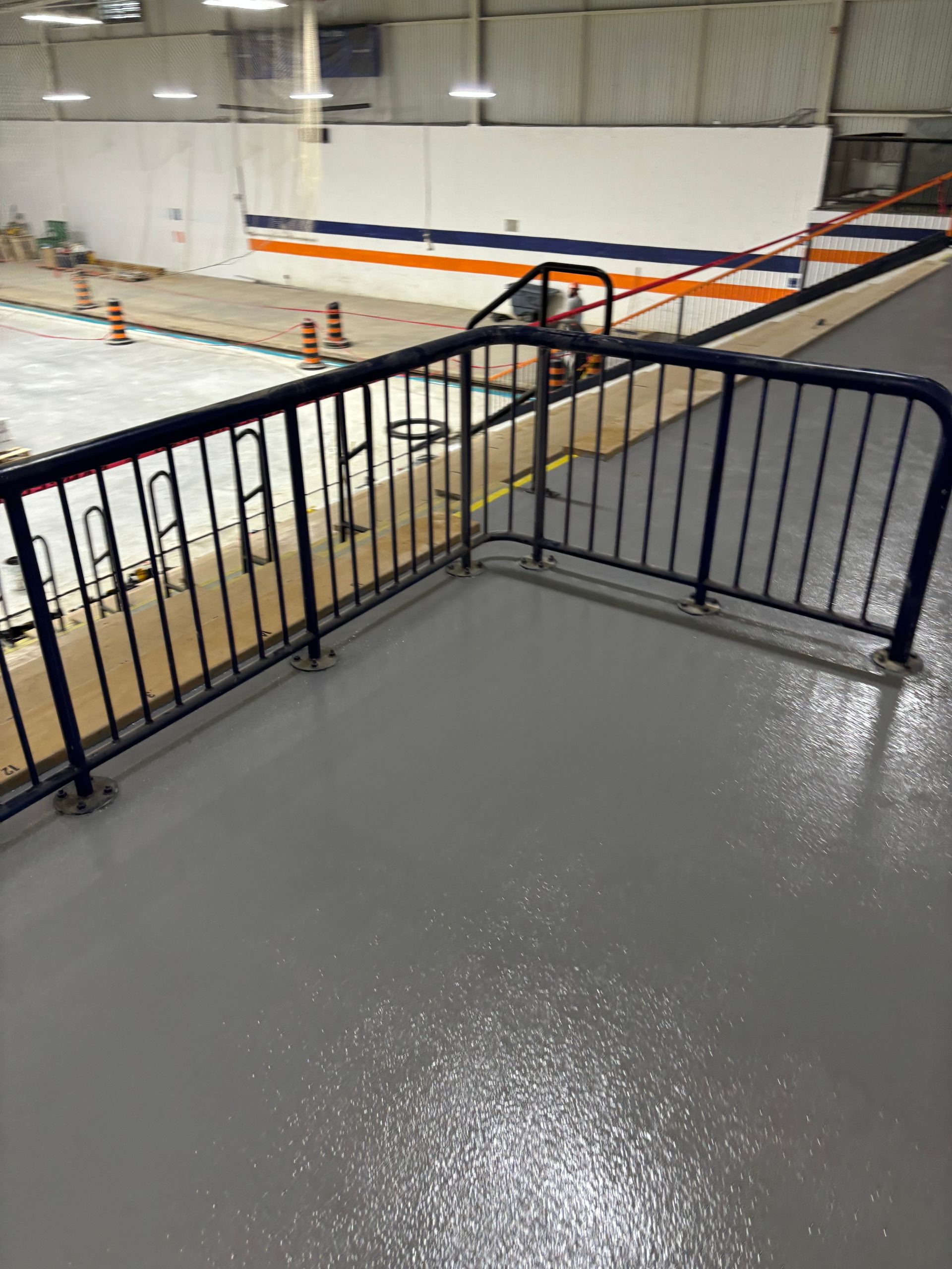 A staircase leading up to a hockey rink with a blue railing