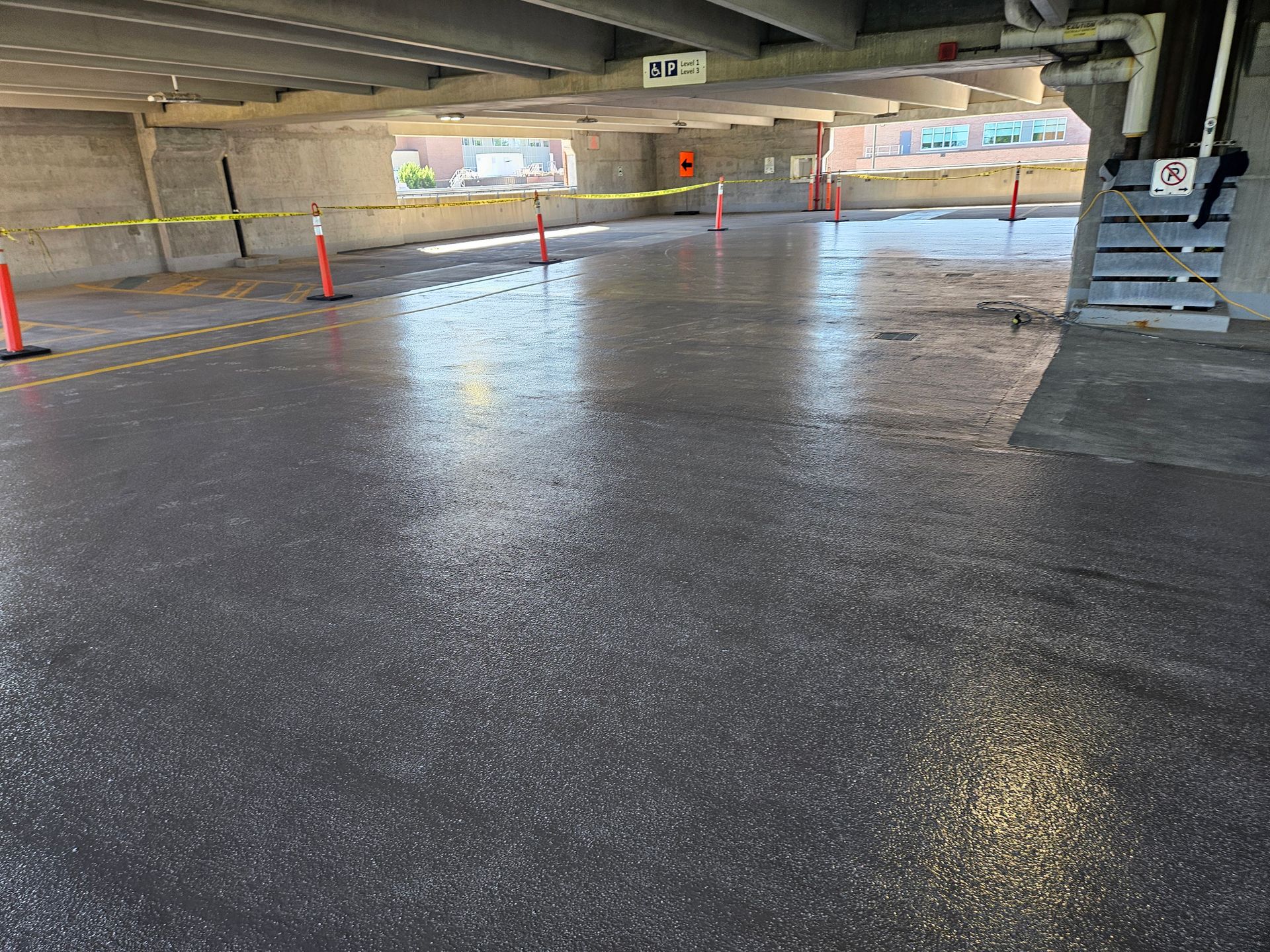 A parking garage with a lot of cones on the floor.