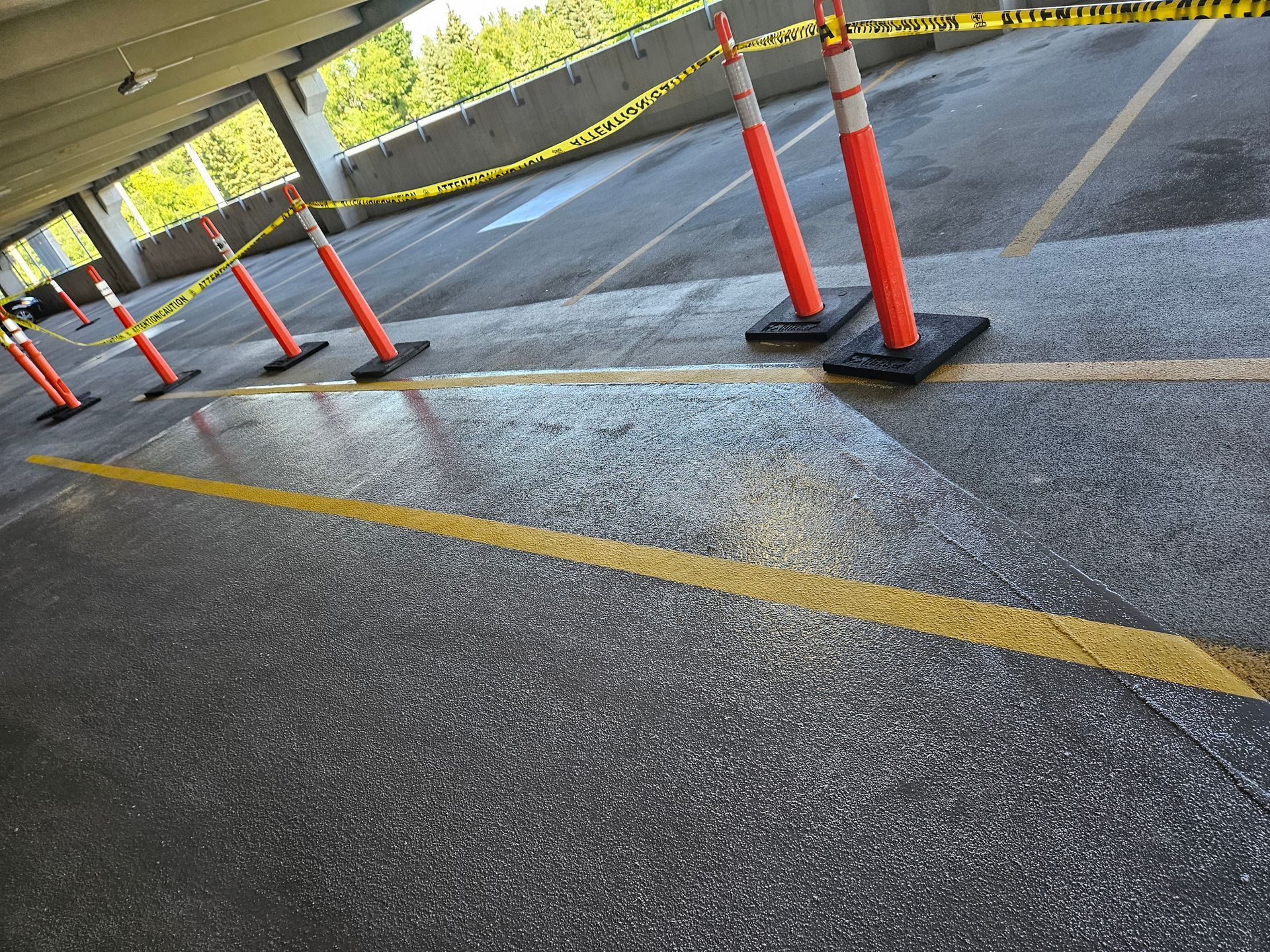 A row of orange and white traffic cones in a parking lot