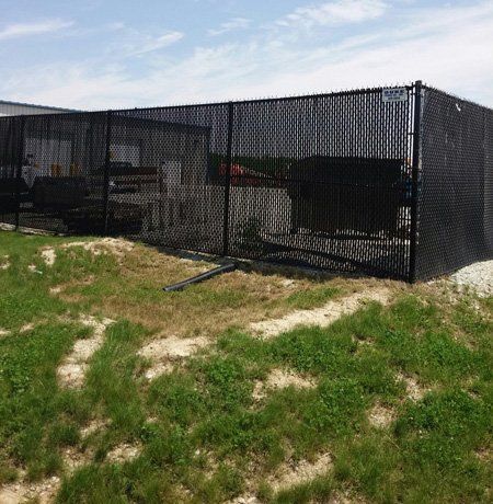 Black chain-link fence encloses an area 