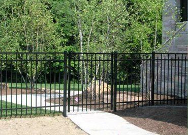 Black metal fence with gate 
