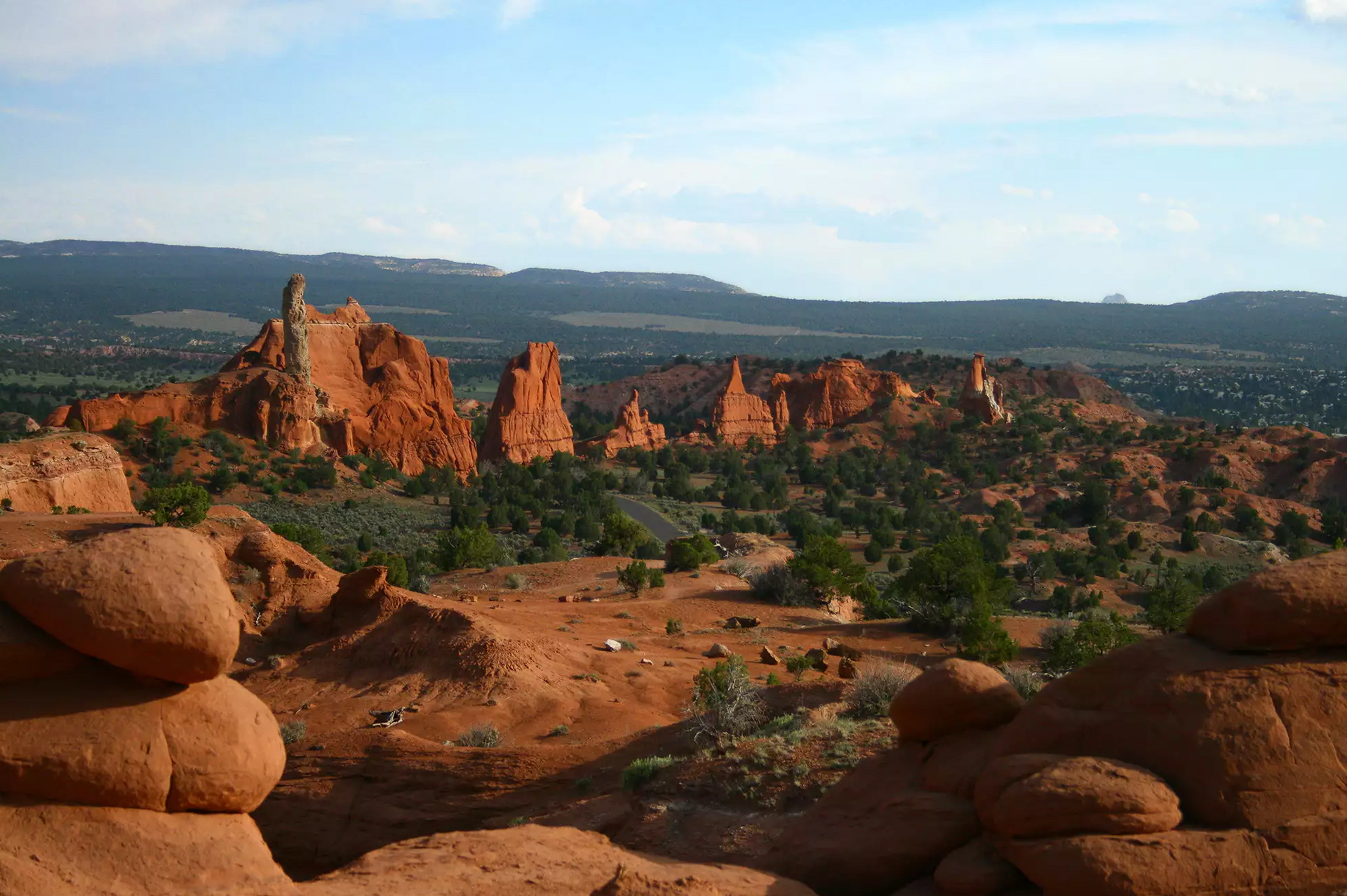 Red rock formations in a desert landscape under a blue sky
