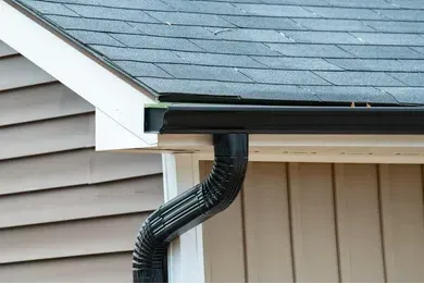 Worker Finishing Folding A Metal Gutter — Akron, OH — D&M Roofing LLC