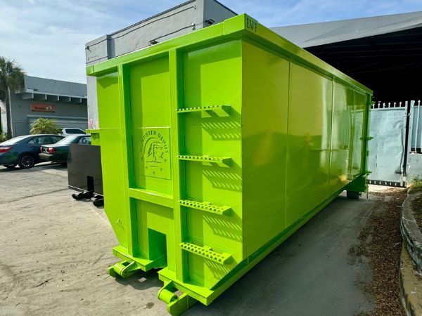 Bright neon green industrial dumpster container on a truck bed in an outdoor lot