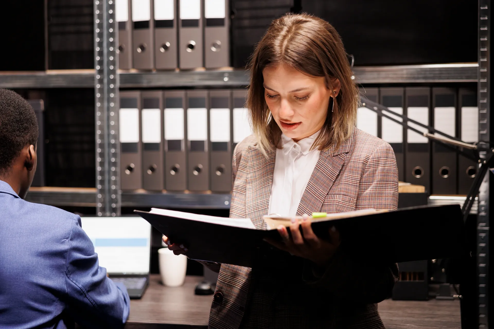 Female background check investigator reviewing record files for Cape Coral and Fort Myers clients.