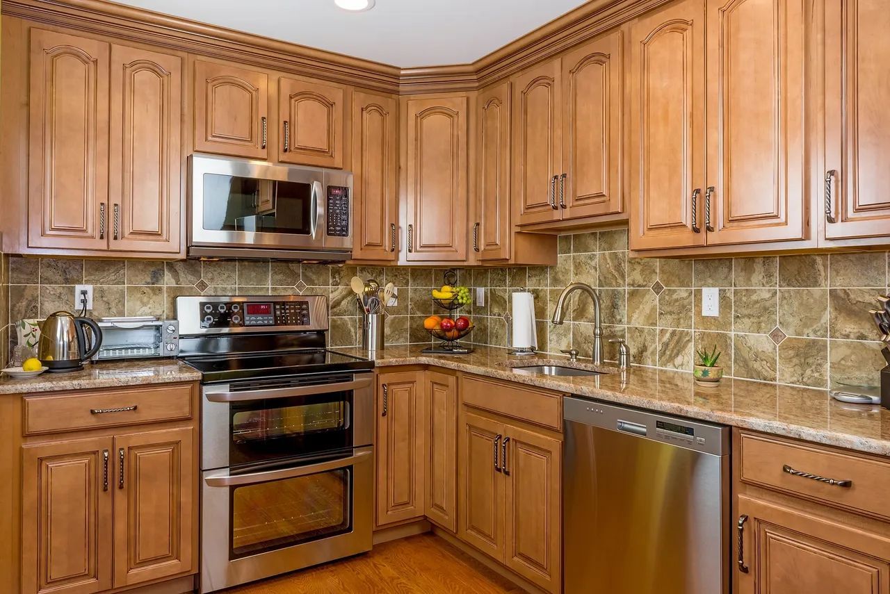 a kitchen with stainless steel appliances and wooden cabinets