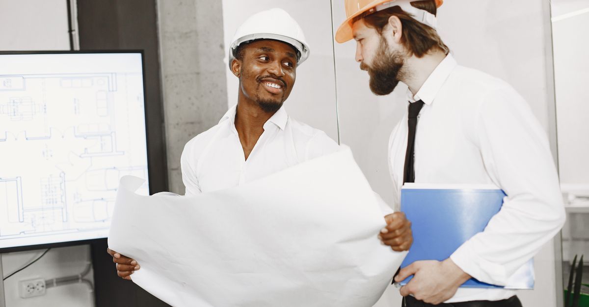 A contractor and homeowner reviewing a construction contract together in Jacksonville, Florida