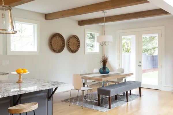 a dining room with a table and chairs and a bench