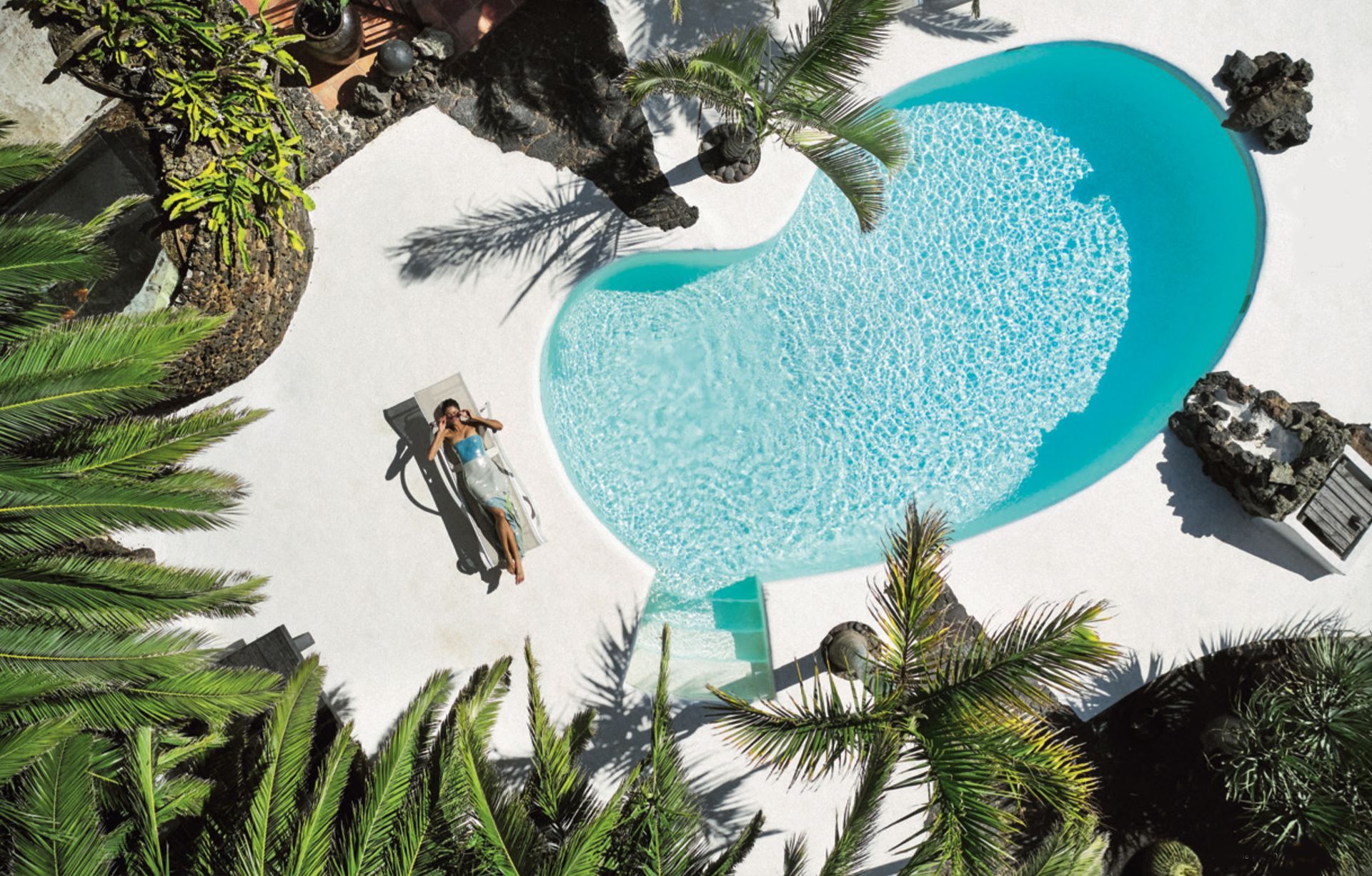 An aerial view of Finca Malvasia swimming pool surrounded by palm trees