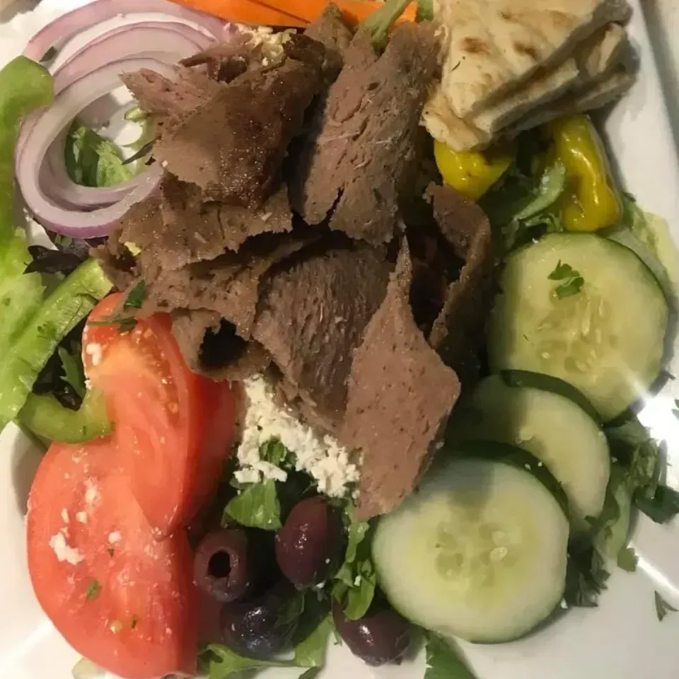 A plate of food with meat and vegetables on it