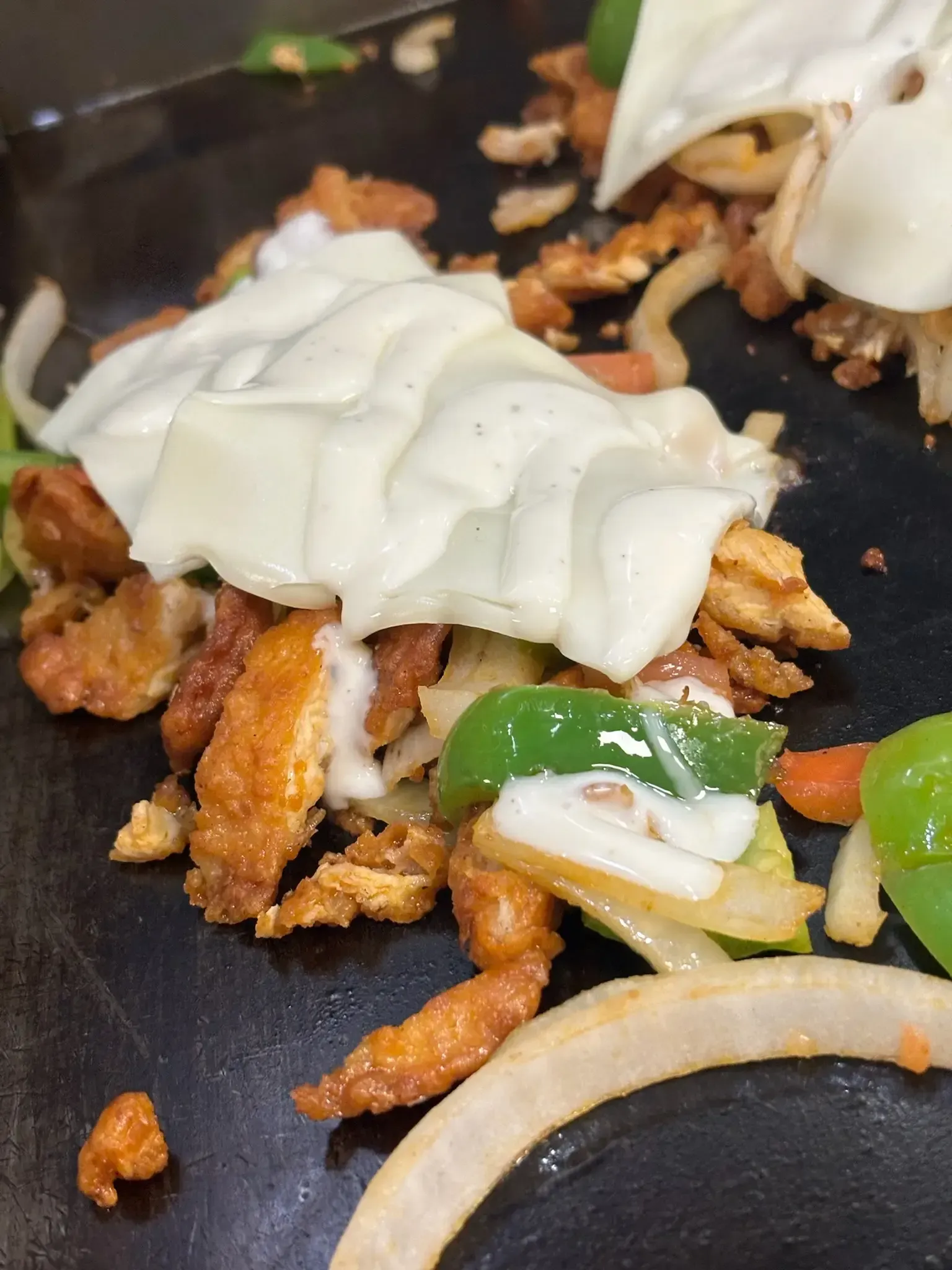A close up of a plate of food with cheese on top