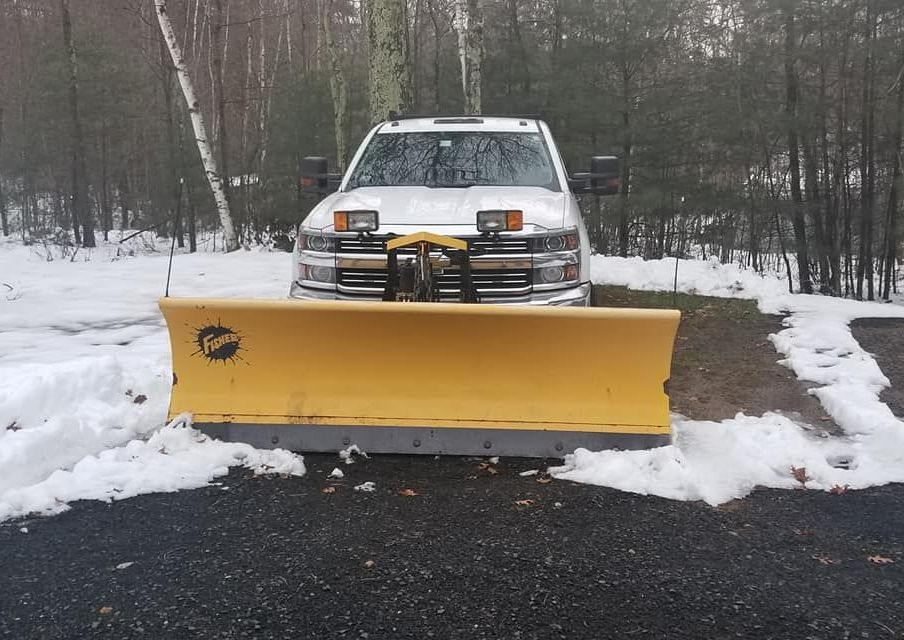 A White Truck With A Yellow Snow Plow On It Is Parked In The Snow — Brimfield, MA — RMD Services, Inc. A White Truck With A Yellow Snow Plow On It Is Parked In The Snow — Brimfield, MA — RMD Services, Inc.
