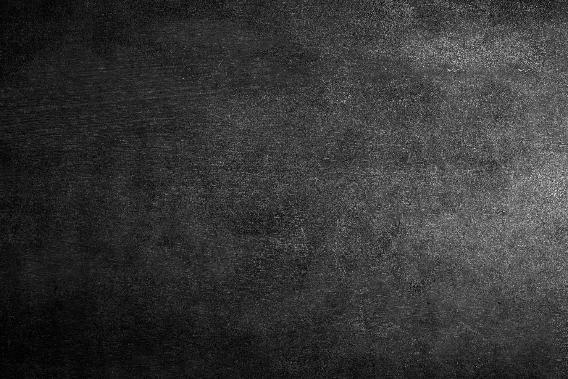 Dark gray textured surface, gradient lighting.