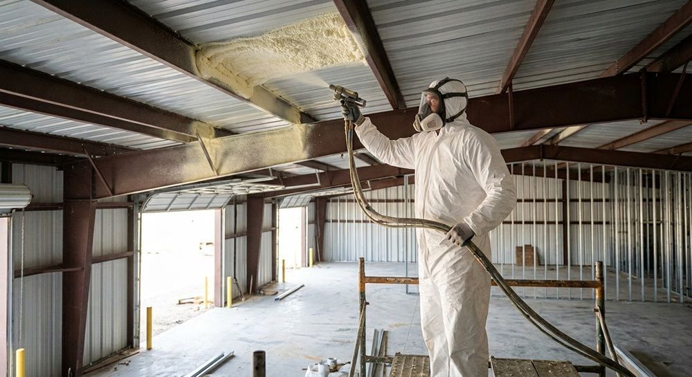 Applying spray foam insulation to a commercial building ceiling in Waco, TX.
