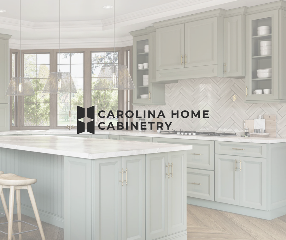 A kitchen with light gray cabinets, a white island, and a herringbone tile backsplash, featuring a company logo overlay.