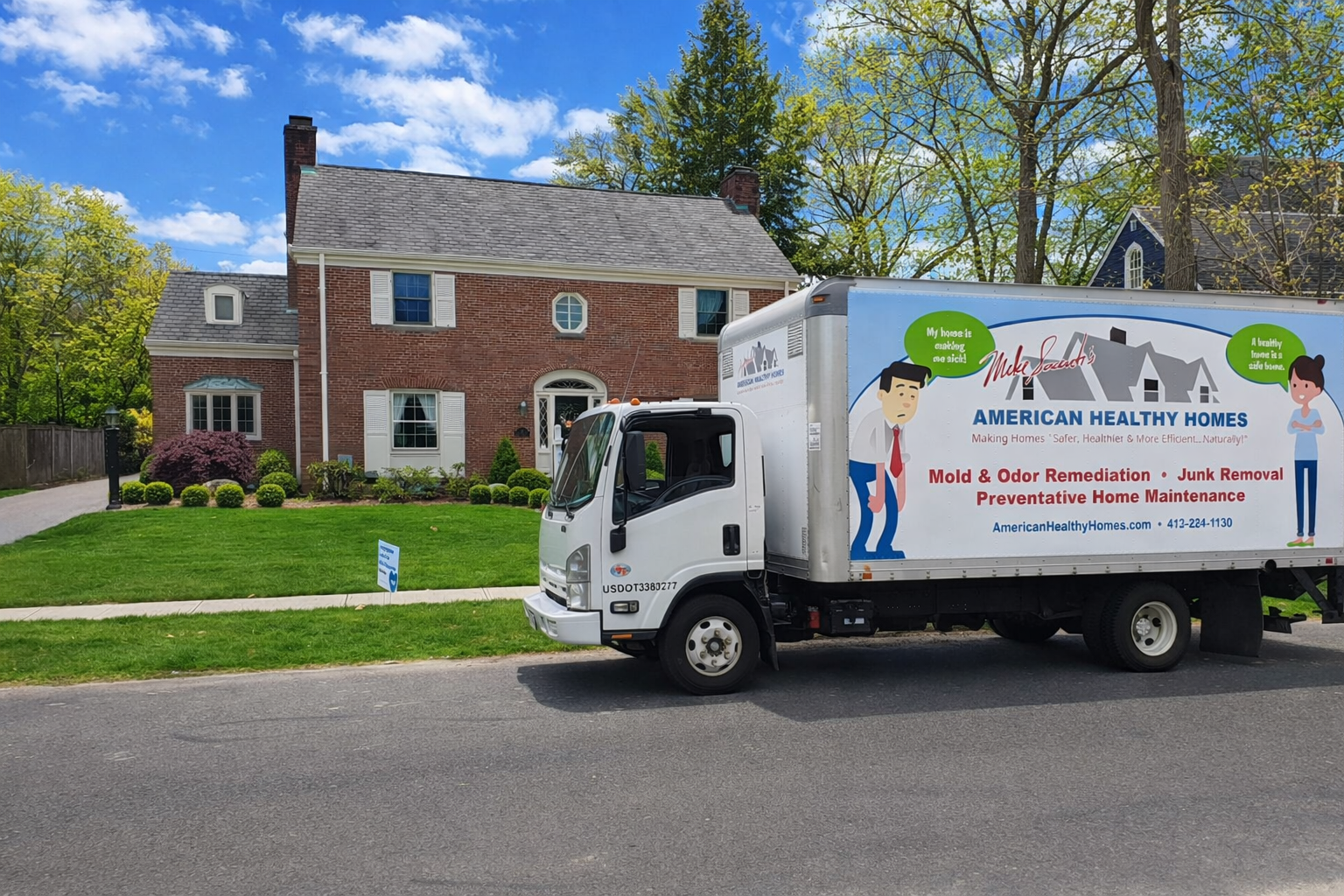 A Healthy Homes service truck parked on a residential street in front of a brick house. A Healthy Homes service truck parked on a residential street in front of a brick house.