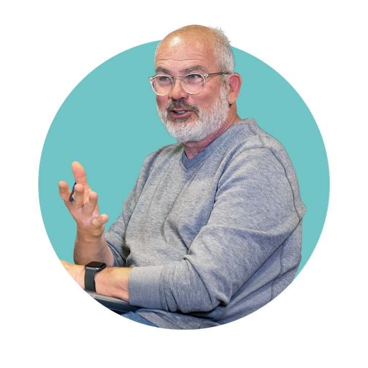 A man with glasses and a beard is talking.