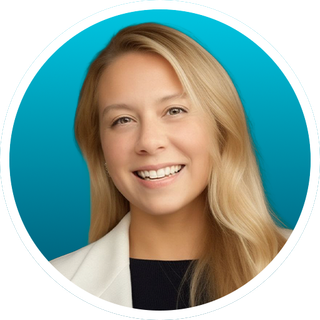 Smiling blonde woman in white blazer against a teal background