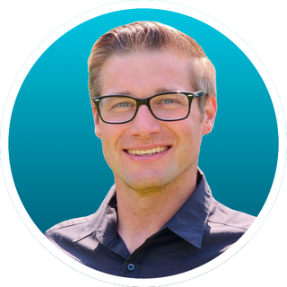 Portrait of a smiling person wearing glasses on a blue background
