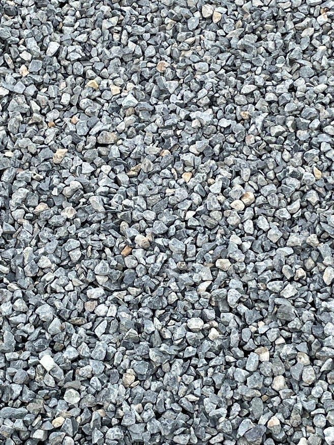 a pile of gravel is sitting on the ground .